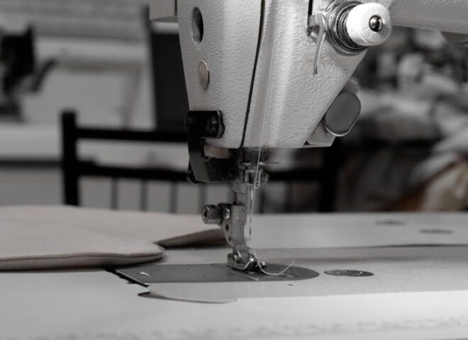 bernina - Closeup of an industrial sewing machine in a textile factory, focused on needle and fabric