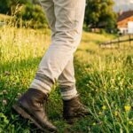 Grasmilben im hohen Gras: Person laeuft im Sommer durch eine Wiese