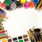 modulor berlin - Creative flat lay of colorful art supplies including paints, pencils, and brushes o